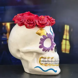 Side profile detail of a hand-painted resin skull figurine with a glittery red rose crown
