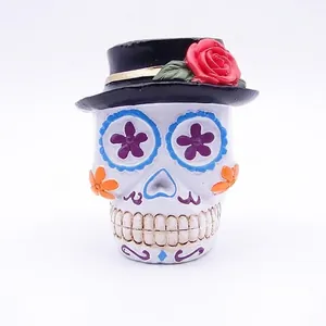 Detailed view of a Mexican Day of the Dead sugar skull resin ornament featuring a rose hat