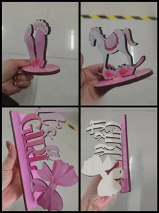 Detail view of pink "It's a Girl" baby shower table decorations and rocking horse