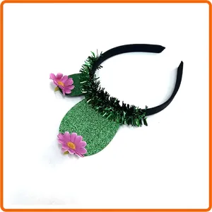 Detail shot of cactus-themed Day of the Dead headband with pink flowers and green tinsel