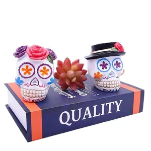 Hand-painted Halloween Day of the Dead sugar skull resin ornaments with floral decorations