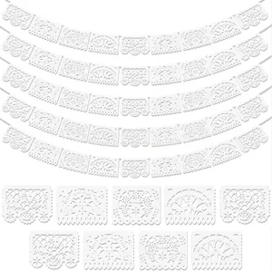 Intricate floral and tree patterns on white Mexican plastic party banners for Day of the Dead