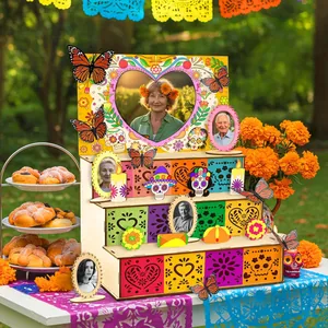 Day of the Dead wooden tiered altar set with photo frames and marigolds in a garden
