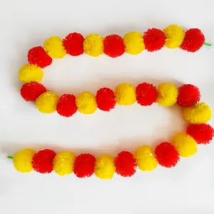 Detailed view of vibrant red and yellow artificial marigold garland for festive decoration