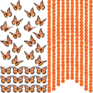 Detail view of artificial marigold garlands and monarch butterflies for Day of the Dead decor