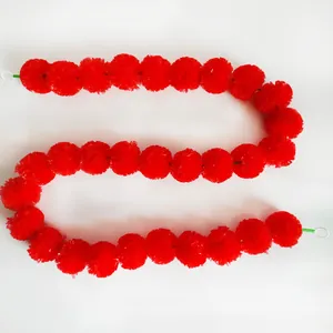Detailed view of bright red artificial marigold garland for festival decoration