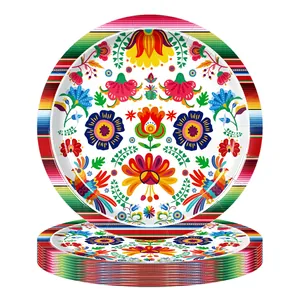 Detail view of festive Mexican party paper plates with colorful floral and bird patterns