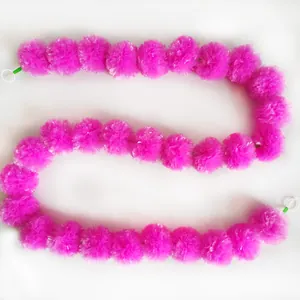 Vibrant pink marigold garland string for Indian weddings and Day of the Dead decorations.