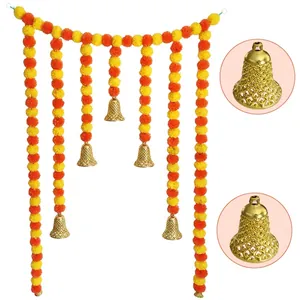 Macro view of golden hollow bells and vibrant marigold flower garland decorations