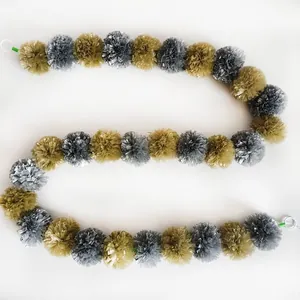 Detailed view of silver and gold marigold pom pom garland for festive party decor