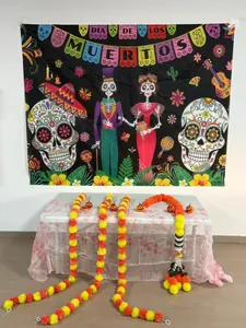 Close-up detail view of orange marigold garlands with Dia de los Muertos backdrop