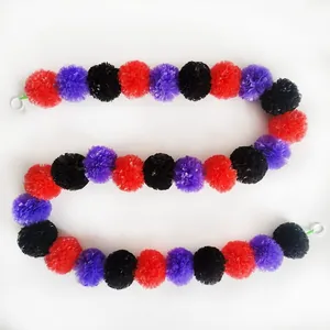 Detailed view of red purple and black marigold garland for Day of the Dead decor