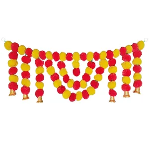 Detailed view of traditional marigold flower garland with red and yellow pom-poms and gold bells