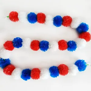 Detailed view of red, white, and blue plastic pom pom garland for festive decorations.