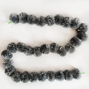 Detailed view of silver plastic marigold garland string for festive event decorations.