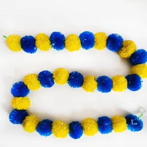Close-up detail of yellow and blue marigold garland for Indian wedding decorations.