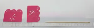 Detailed macro shot of a pink felt Day of the Dead cupcake topper shown with a ruler scale