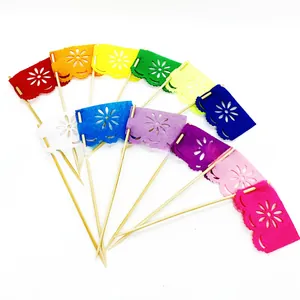 Detailed view of 12 colorful Day of the Dead floral cutout cake toppers with wooden picks