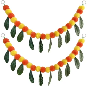 Detail view of artificial marigold and mango leaf garland for Day of the Dead decor.
