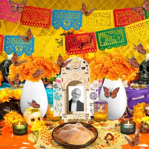 Vibrant Day of the Dead altar kit with orange marigolds, banners, and butterflies.