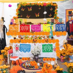 Mexican Day of the Dead decor set with marigold garlands and papel picado banners.