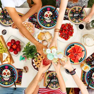 Top-down view of Day of the Dead party table with decorative sugar skull plates