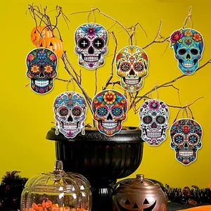 Set of vibrant sugar skull wooden ornaments hanging on a decorative branch