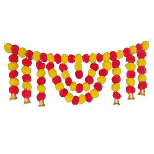 Detailed view of red and yellow marigold garland with golden bells for festival decor