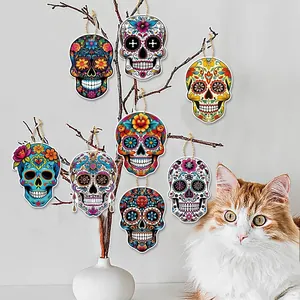 Detailed view of colorful wooden sugar skull ornaments hanging on decorative branches