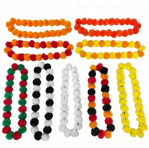 Detailed view of artificial marigold flower garlands in multiple colors and patterns.