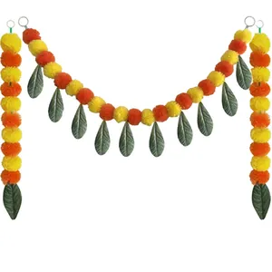 Traditional artificial marigold garland with orange and yellow pom-poms and green leaves