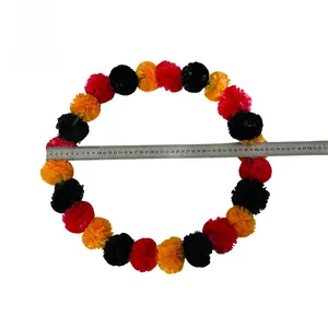 Multi-color fabric marigold garland shown with a ruler measuring diameter