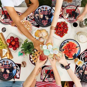 Top view of vibrant birthday party table featuring Stray Kids themed plates and napkins