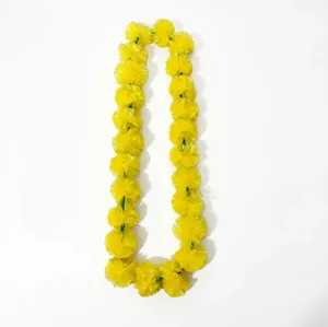 Detailed view of artificial yellow marigold flower garland for festive decorations