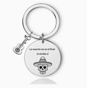 Macro view of stainless steel keychain with Spanish quote and guitar skull details.