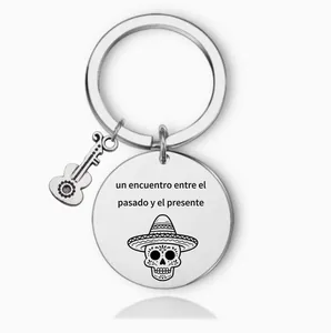 Close-up detail of engraved Day of the Dead skull and Spanish text on steel keychain