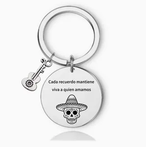 Detail view of Mexican stainless steel keychain with Spanish quote and guitar charm