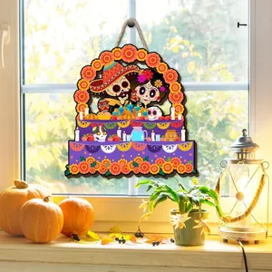 Day of the Dead wooden plaque hanging on a window with pumpkins and lantern decoration