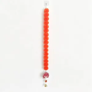 Vibrant orange marigold garland with lotus pendant and bell for festive decor.