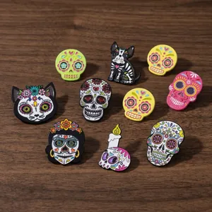 Colorful Day of the Dead sugar skull enamel pins on a wooden background