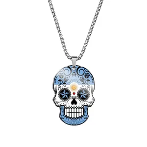 Detail of stainless steel sugar skull pendant featuring an Argentina flag print and sun motif.