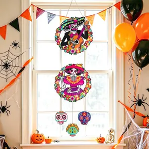 Detail view of colorful Day of the Dead sugar skull hanging decorations on a festive window