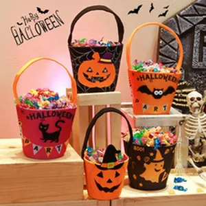 Variety of Halloween candy buckets with festive pumpkin and ghost prints.
