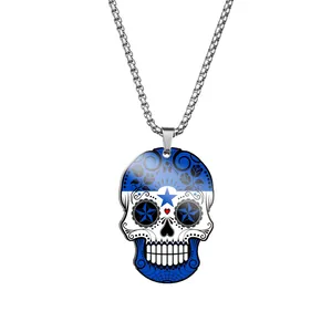 Detail view of a stainless steel sugar skull pendant with blue flag star design