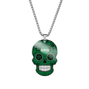 Close-up of green Day of the Dead skull pendant with Arabic script on stainless steel chain