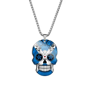 Detail shot of a blue and white sugar skull pendant with Scottish flag pattern on a chain.