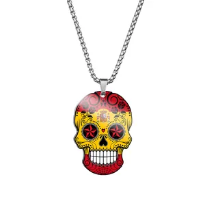 Detailed view of a stainless steel sugar skull pendant featuring vibrant Spanish flag colors