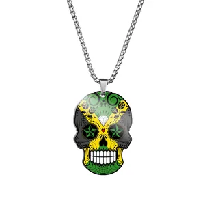 Detail view of a stainless steel necklace with a colorful Jamaican flag sugar skull