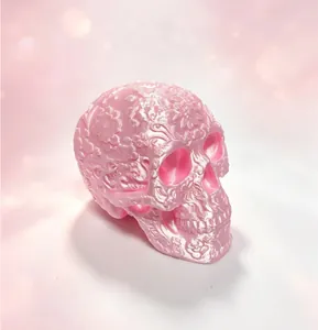 Close-up of pink 3D printed skull with intricate floral relief for gothic decor