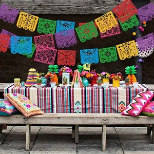 Vibrant Mexican party felt banners hanging above a festive outdoor themed table setup